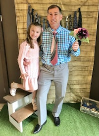 a man and a little girl posing for a photo