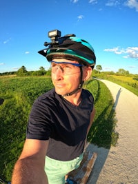 a man on a bike taking a selfie on a path