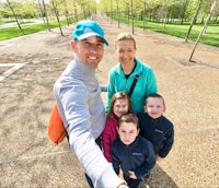 a family is taking a selfie in a park