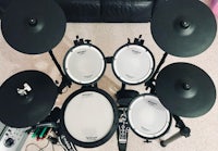 a drum set sitting on a floor in a living room