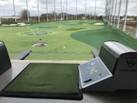 a golf course with a computer and a golf ball