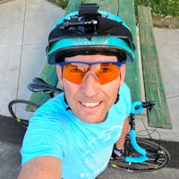 a man taking a selfie with his bike and sunglasses