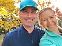 a man and woman taking a selfie in the fall