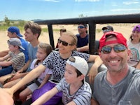 a group of people taking a selfie in a jeep