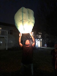 a man holding up a kite