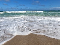 a beach with waves crashing on the sand