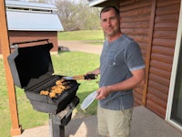 a man grilling chicken on a grill