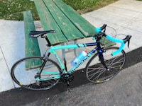 a bike leaning against a picnic table