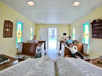 a group of people sitting in a room with an open book