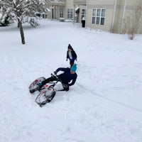 two people riding a snow bike in the snow