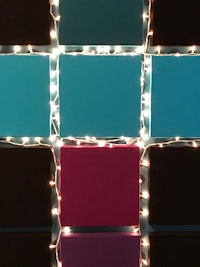 a wall covered in lights with squares of different colors